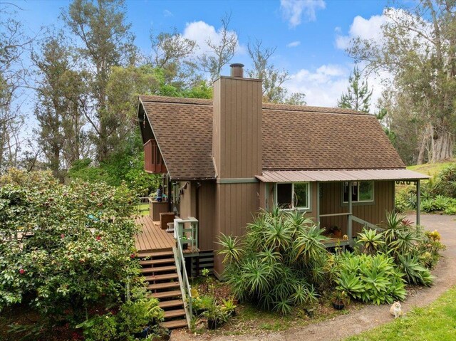 2450 Piiholo Rd, Makawao, HI 96768 - view of front of home featuring roof with shingles, a deck, stairway, and a chimney