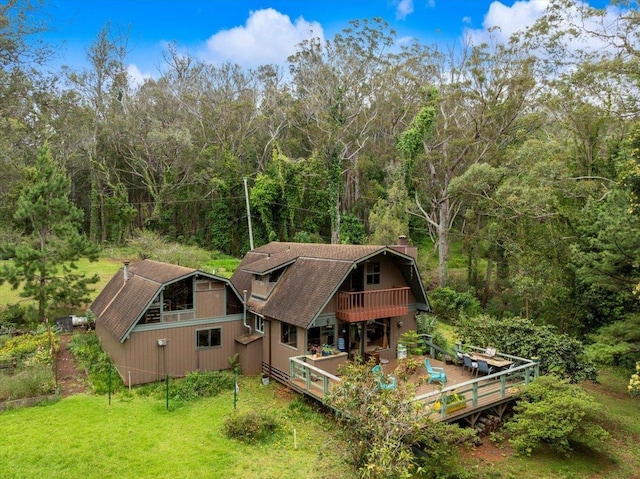 2450 Piiholo Rd, Makawao, HI 96768 - rear view of house featuring a gambrel roof, a wooden deck, a forest view, and a chimney