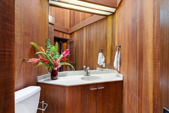 2450 Piiholo Rd, Makawao, HI 96768 - bathroom with toilet, vanity, and wooden walls