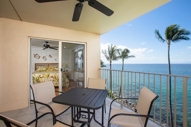 balcony featuring ceiling fan and a water view