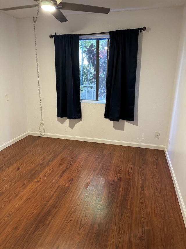 spare room with hardwood / wood-style flooring and ceiling fan