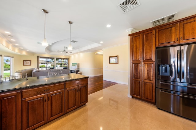 kitchen featuring ceiling fan, hanging light fixtures, stainless steel refrigerator with ice dispenser, light tile patterned floors, and a tray ceiling