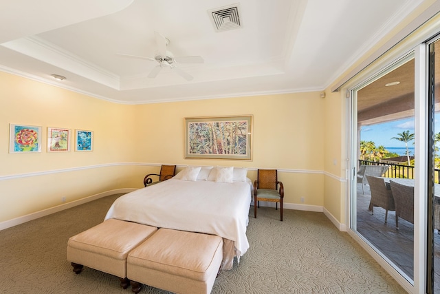 bedroom with ceiling fan, access to outside, ornamental molding, a tray ceiling, and light colored carpet