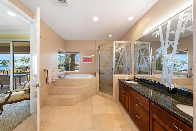 bathroom featuring double sink vanity, tile patterned flooring, and separate shower and tub