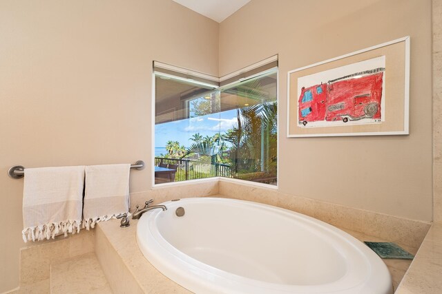 bathroom featuring a relaxing tiled tub