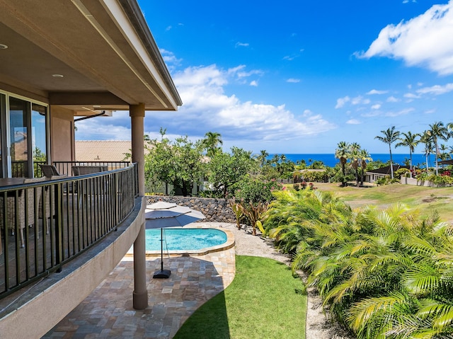 view of swimming pool featuring a water view and a patio area