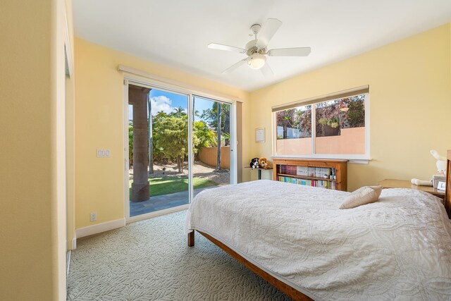 carpeted bedroom with ceiling fan, access to outside, and multiple windows