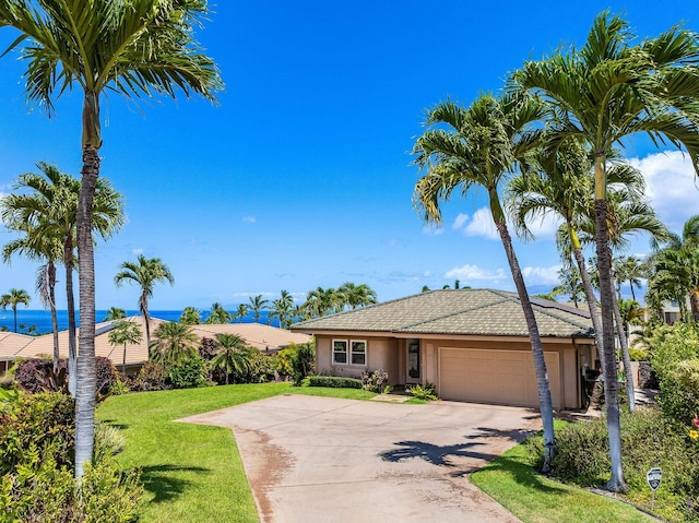 view of front of house featuring a front lawn and a garage