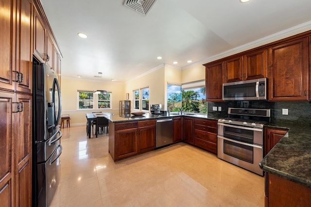 kitchen featuring appliances with stainless steel finishes, kitchen peninsula, light tile patterned flooring, backsplash, and sink