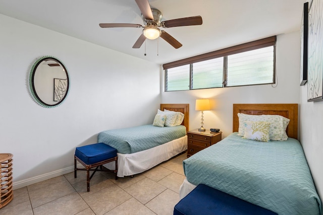 bedroom featuring ceiling fan and light tile patterned flooring