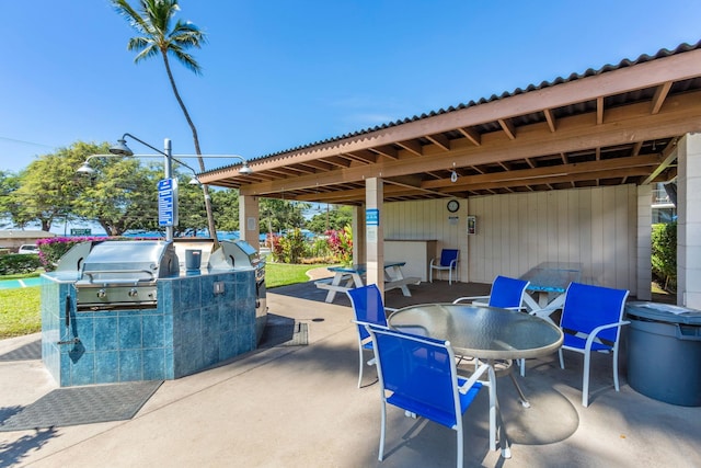 view of patio featuring an outdoor kitchen and a grill