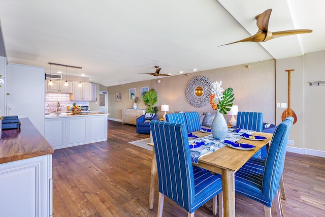 dining space with dark wood-type flooring and sink