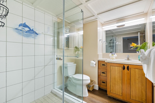 bathroom featuring wood-type flooring, vanity, toilet, and a shower with door