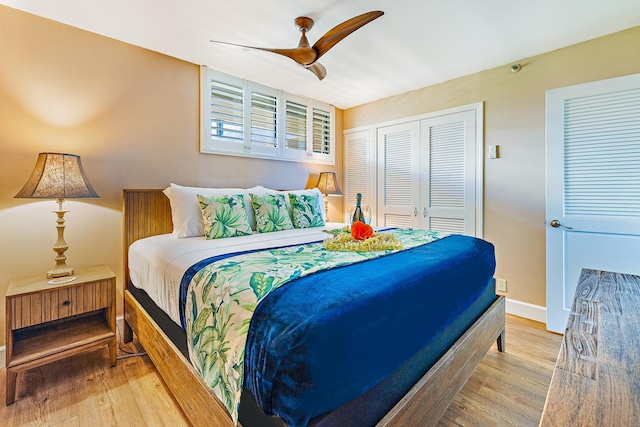 bedroom featuring hardwood / wood-style flooring, ceiling fan, and a closet