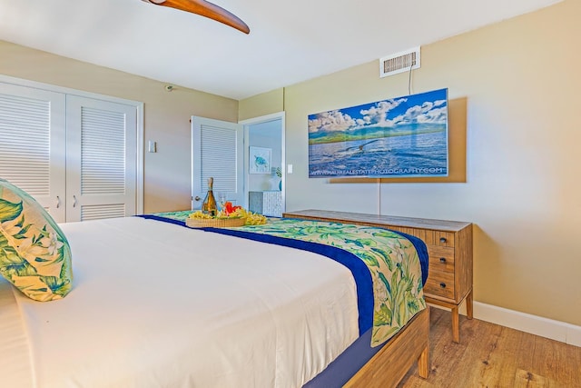 bedroom with a closet, hardwood / wood-style flooring, and ceiling fan