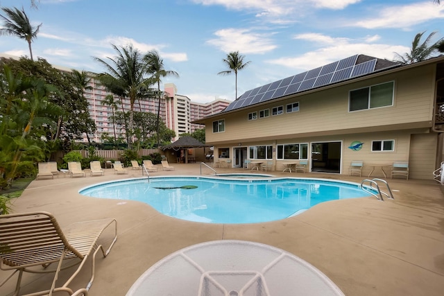 view of pool featuring a community hot tub and a patio