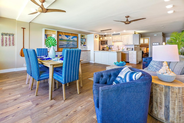 dining room with light hardwood / wood-style floors and sink