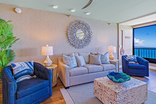 living room with ceiling fan and dark hardwood / wood-style floors