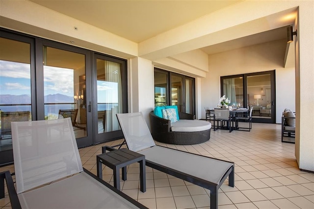 view of terrace with french doors and a mountain view