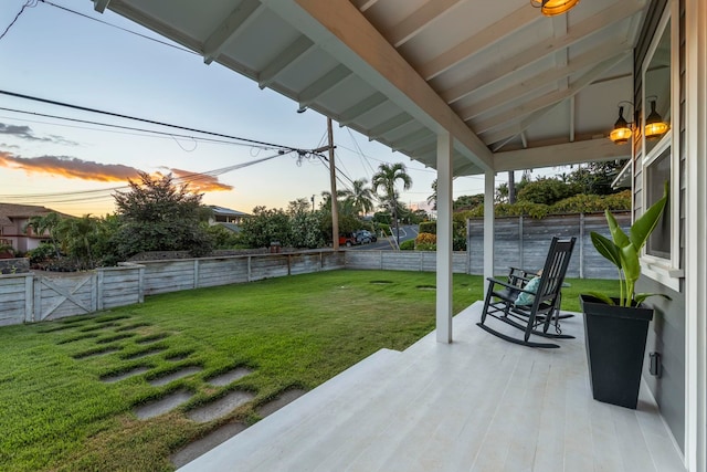 yard at dusk featuring a patio