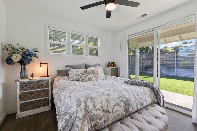 bedroom featuring dark hardwood / wood-style floors, ceiling fan, and access to exterior