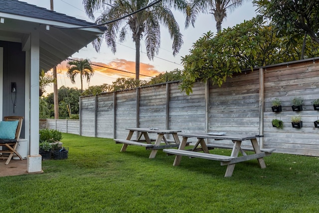 view of yard at dusk