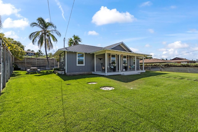 rear view of property with a lawn