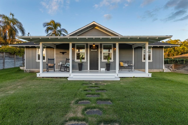 rear view of property with a yard and a deck