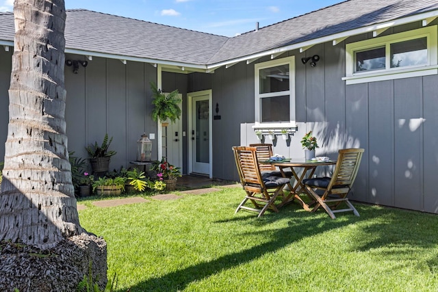 view of exterior entry featuring a lawn