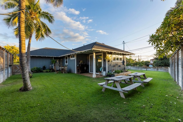 back of house featuring a lawn