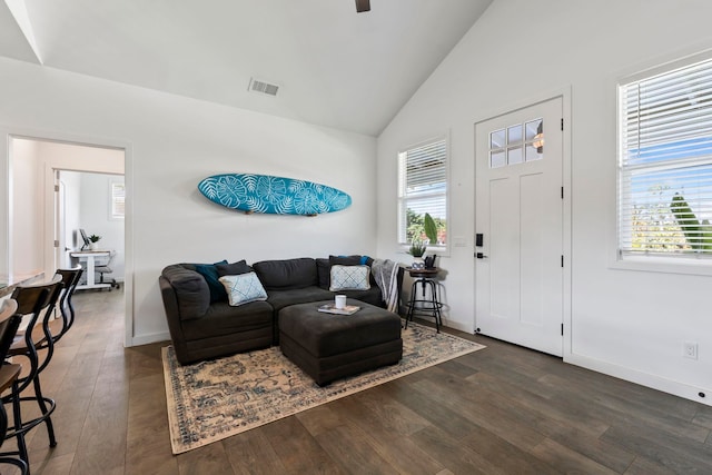 living room featuring dark hardwood / wood-style floors and vaulted ceiling