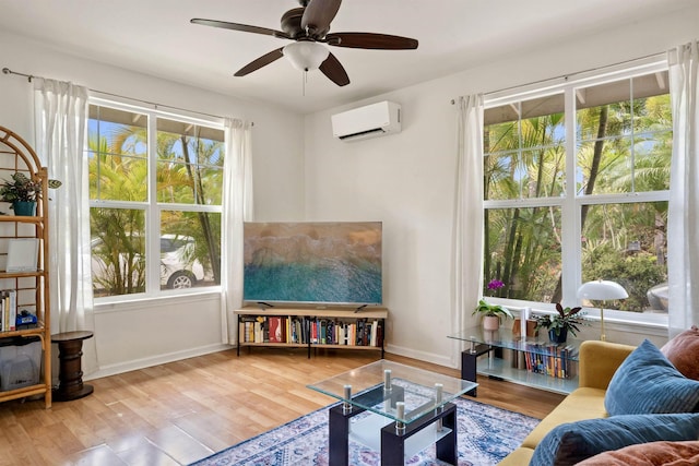 206 Kuli Puu St, Kihei, HI 96753 - living room featuring a wall unit AC, ceiling fan, baseboards, and wood finished floors