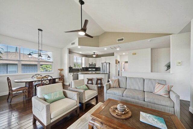 206 Kuli Puu St, Kihei, HI 96753 - living room with vaulted ceiling, a ceiling fan, dark wood-type flooring, and baseboards