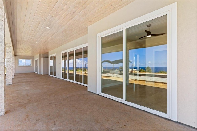 exterior space featuring ceiling fan and wooden ceiling