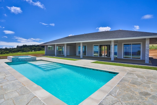 view of pool with a patio area and an in ground hot tub