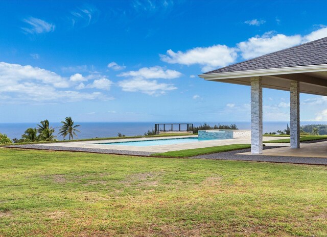 back of house featuring a patio and a pool with hot tub