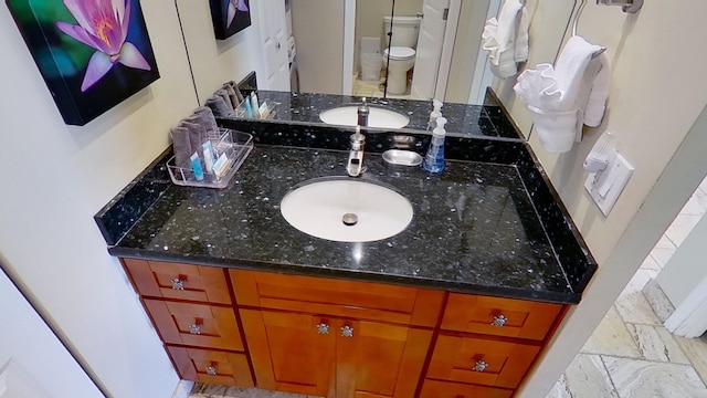 bathroom featuring vanity and toilet