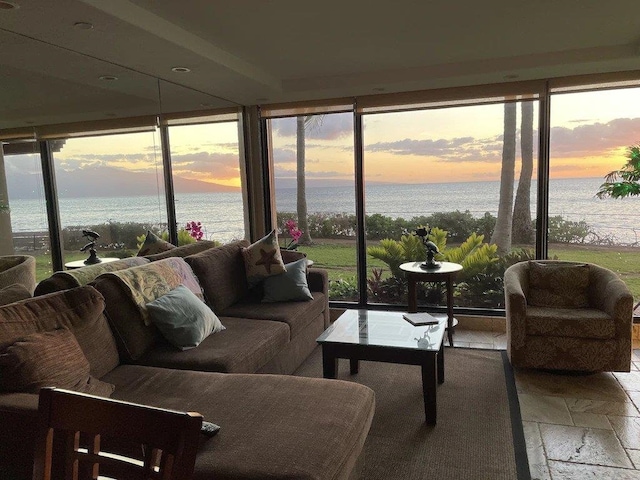 sunroom / solarium featuring a water view