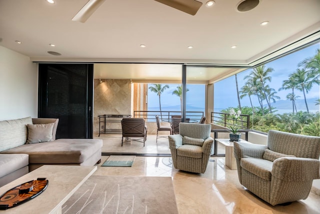 living room with light tile floors, a wall of windows, and a water view