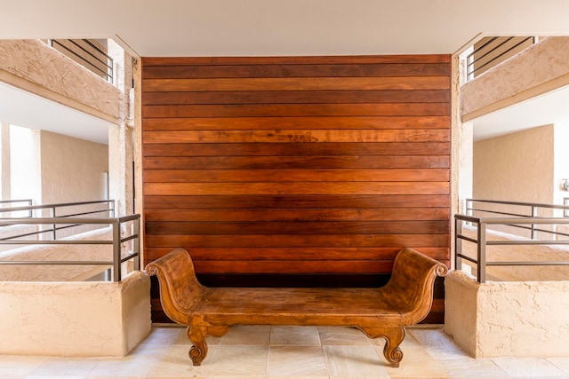 living area featuring light tile flooring and a high ceiling