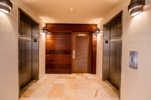 hall featuring light tile floors and elevator