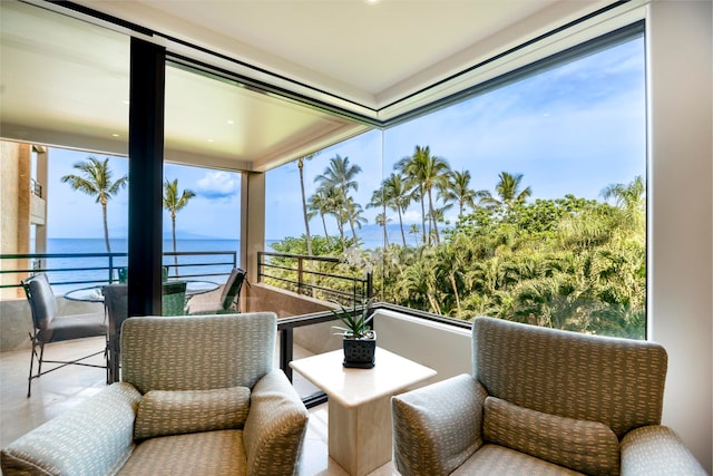 sunroom with a water view and a wealth of natural light