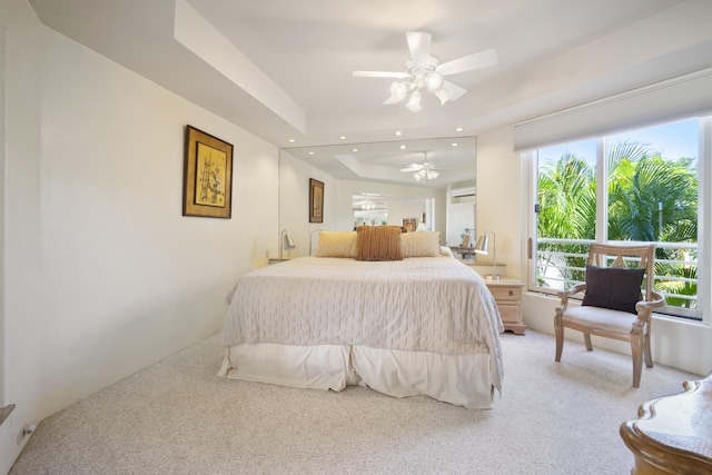 bedroom featuring recessed lighting, a raised ceiling, an AC wall unit, and light colored carpet