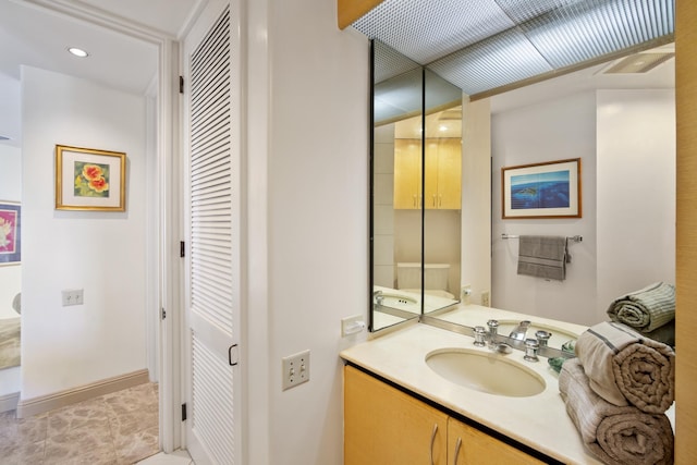 bathroom with vanity and baseboards