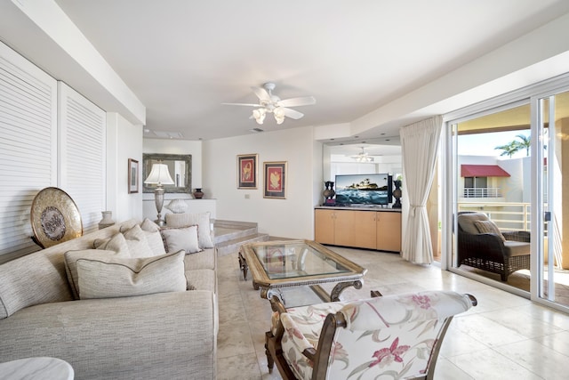 living room with a ceiling fan and light tile patterned flooring