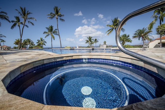 view of pool with a hot tub