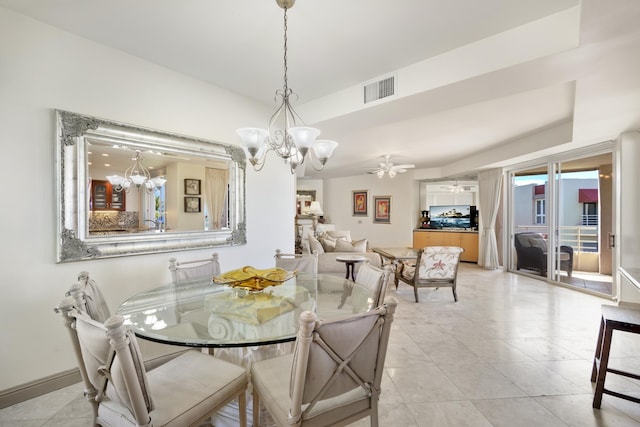 dining room featuring ceiling fan with notable chandelier, visible vents, baseboards, and light tile patterned flooring