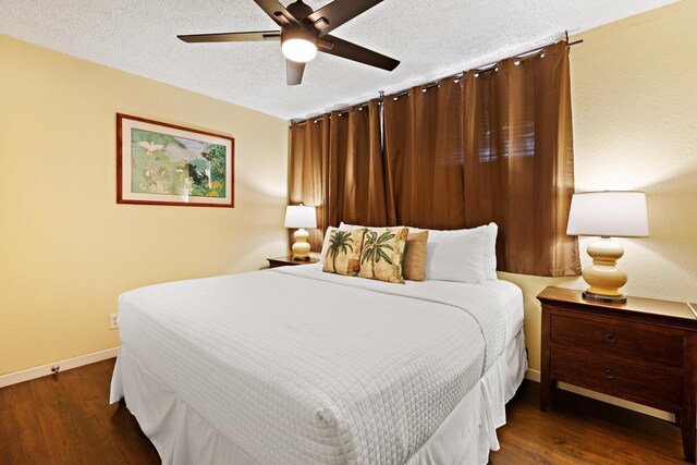 bedroom featuring ceiling fan, a textured ceiling, and dark hardwood / wood-style flooring