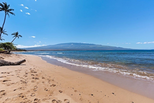 water view with a mountain view and a view of the beach