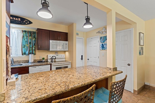 280 Hauoli Rd Unit A16, Wailuku, HI 96793 - kitchen with white appliances, light stone counters, dark brown cabinetry, baseboards, and decorative light fixtures
